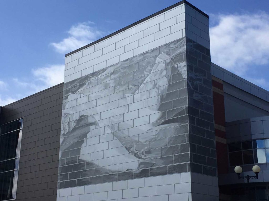 A wall on the outside of the convention centre is made with stone that creates the image of an iceberg breaking apart