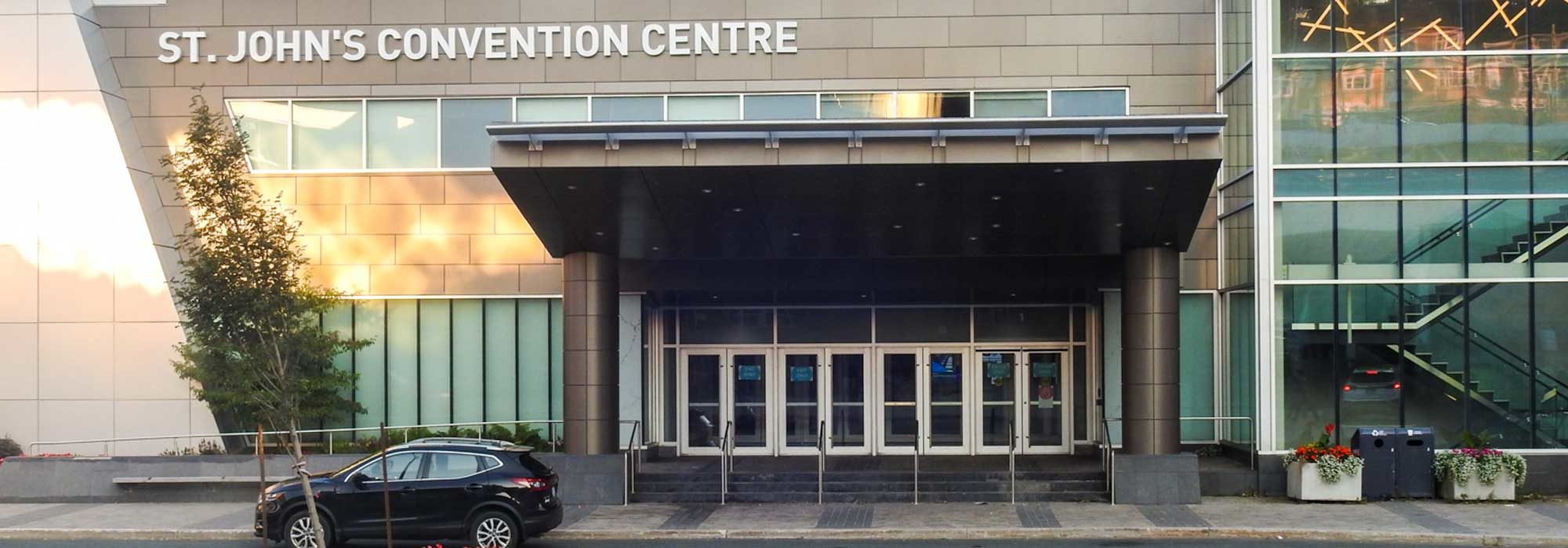 The exterior of the St. John's convention centre in daylight.